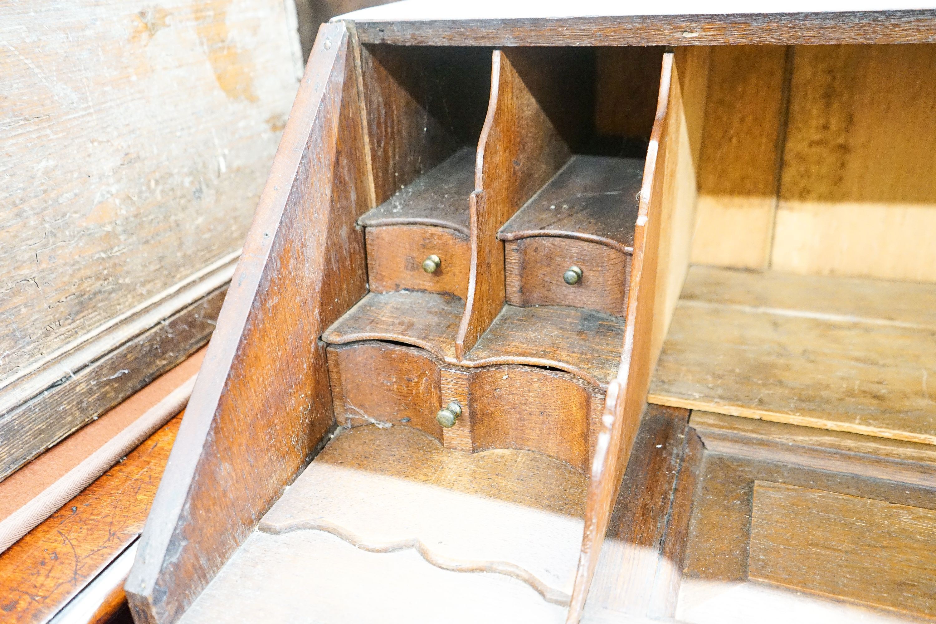 An 18th century later carved oak bureau, width 91cm, depth 53cm, height 101cm